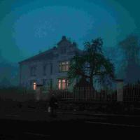 An old, eerie house at night.