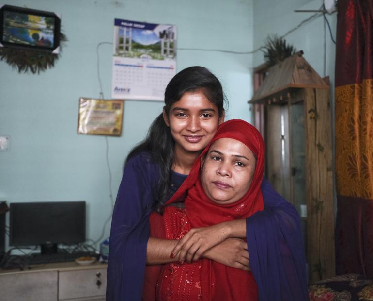  Sharmin Akhter Eti (left), 18, poses for a portrait with her mother, Minu Alam, 36, at their home in Dhaka, Bangladesh. Eti is a Peer Educator with the Adolescent Friendly Health Services (AFHS) programme.  “Receiving counselling from the programme, my daughter achieved skills needed to tackle issues which hinder her psychological well-being. She even can consult and clear up many confusions and misinformation of mine or many others like me,” says the mother.