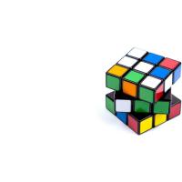 A picture of Rubik cube, with some of its parts shifter in different positions.